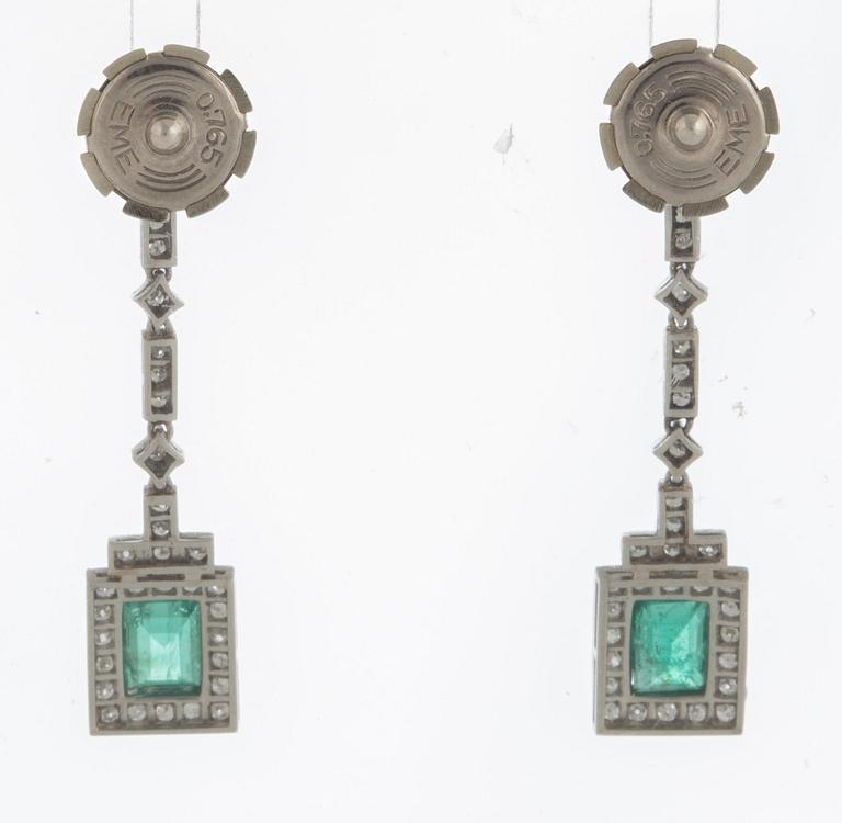 A pair of emerald earrings set with eight-cut diamonds.