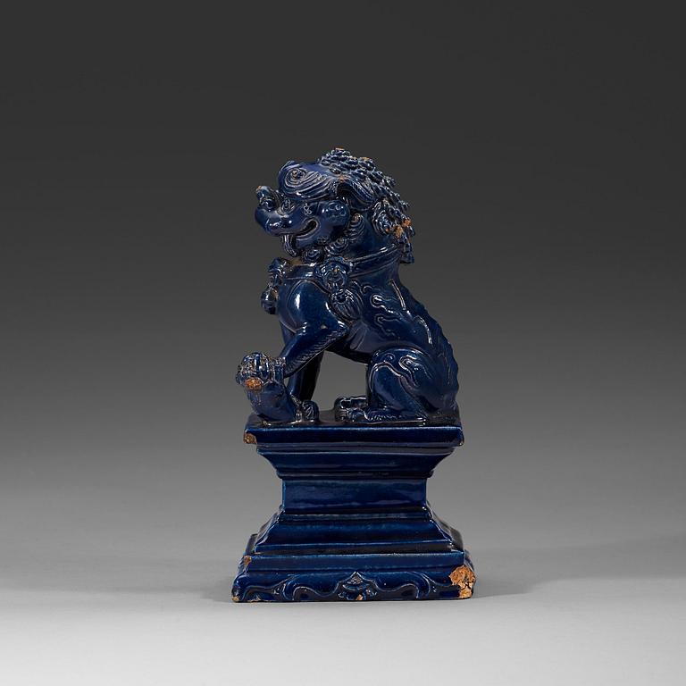 A seated blue glazed buddhist lion, Ming dynasty, 17th Century.