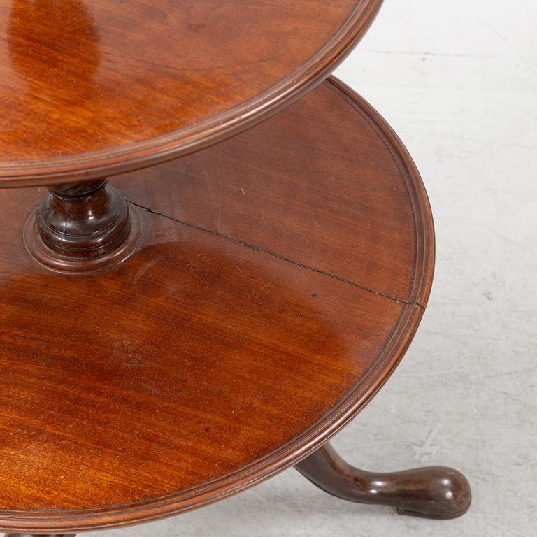 A mahogany three-tier table, England, circa 1900.