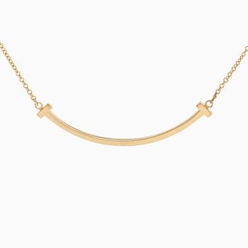 Tiffany & Co, an 18K gold 'T Smile' necklace.