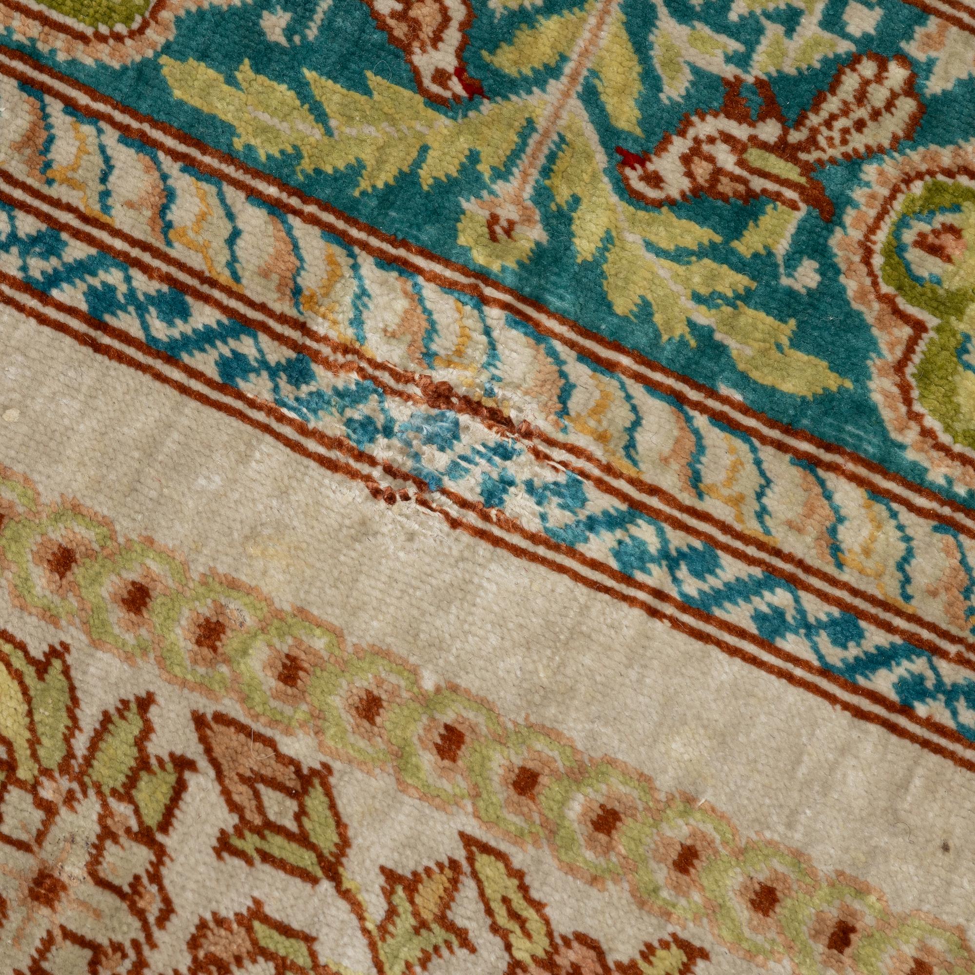 A semi-antique silk Hereke, c. 92 x 61 cm.