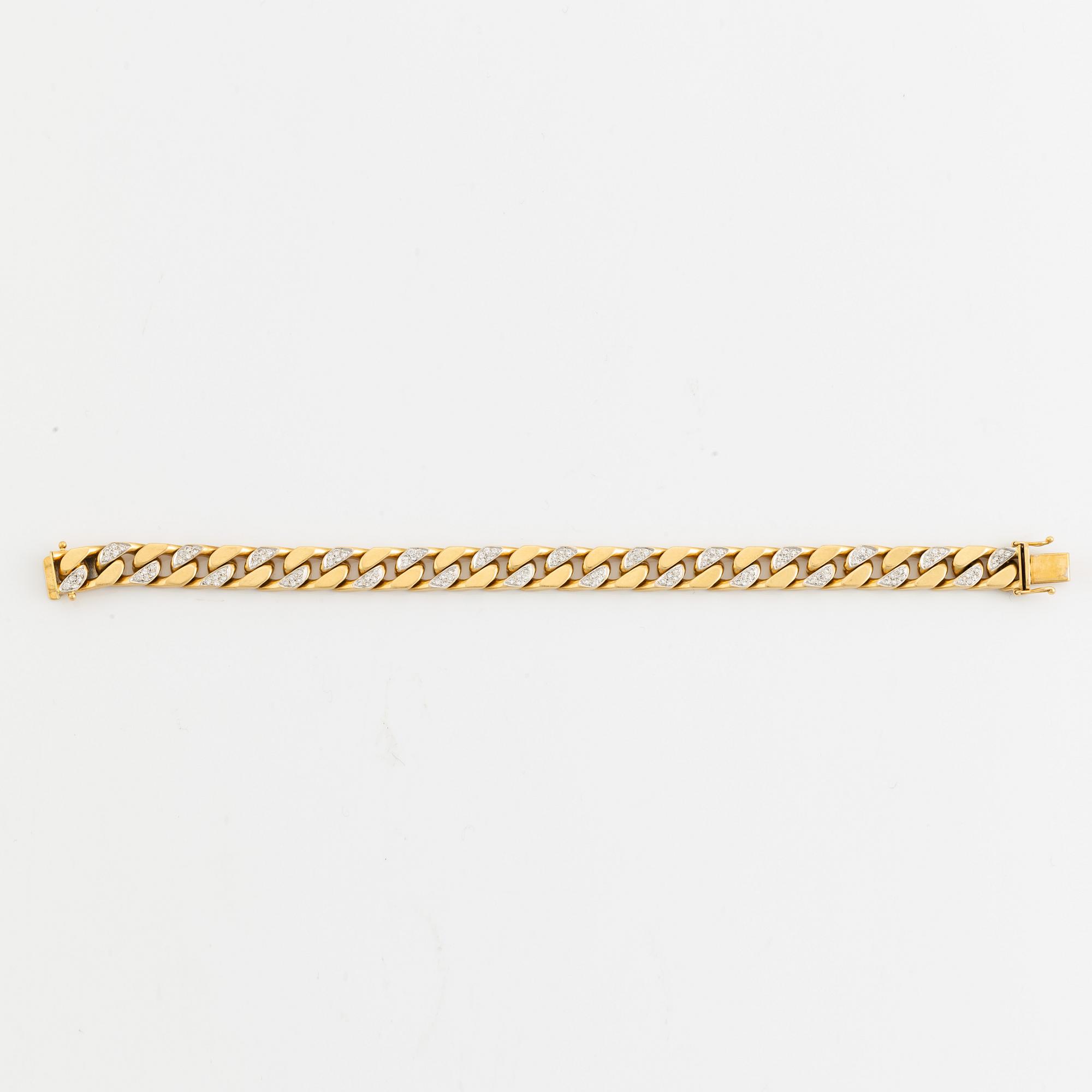 18K gold and brilliant cut diamond curb link bracelet.