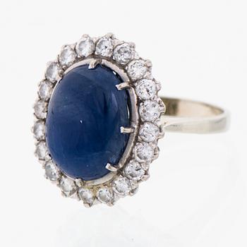 A RING, cabochon cut star sapphire, brilliant cut diamonds, 18K white gold.