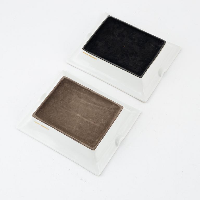 Two Hermès porcelain ashtrays.