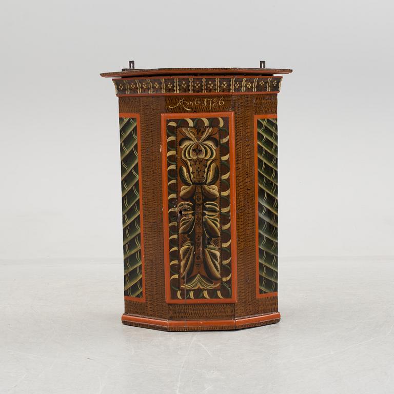 A folk art corner cabinet.