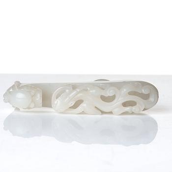 A sculptured nephrite belt buckle, figurine and brush washer, late Qing dynasty.