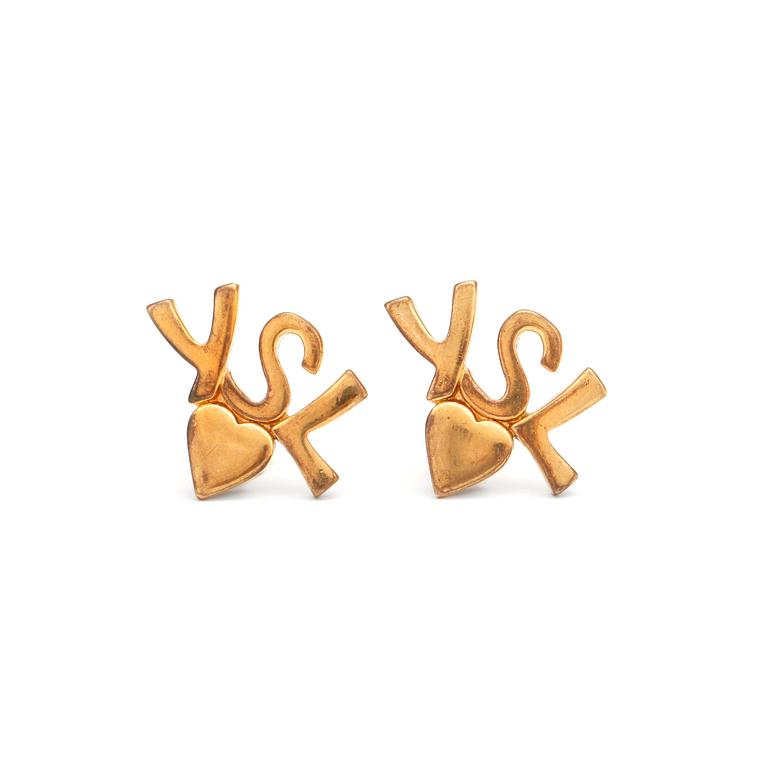 YVES SAINT LAURENT, a pair of gold colored logo earclips.