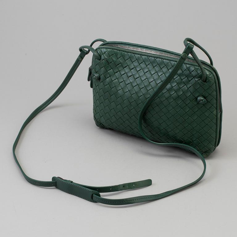 A green Bottega Veneta cross-body  handbag.