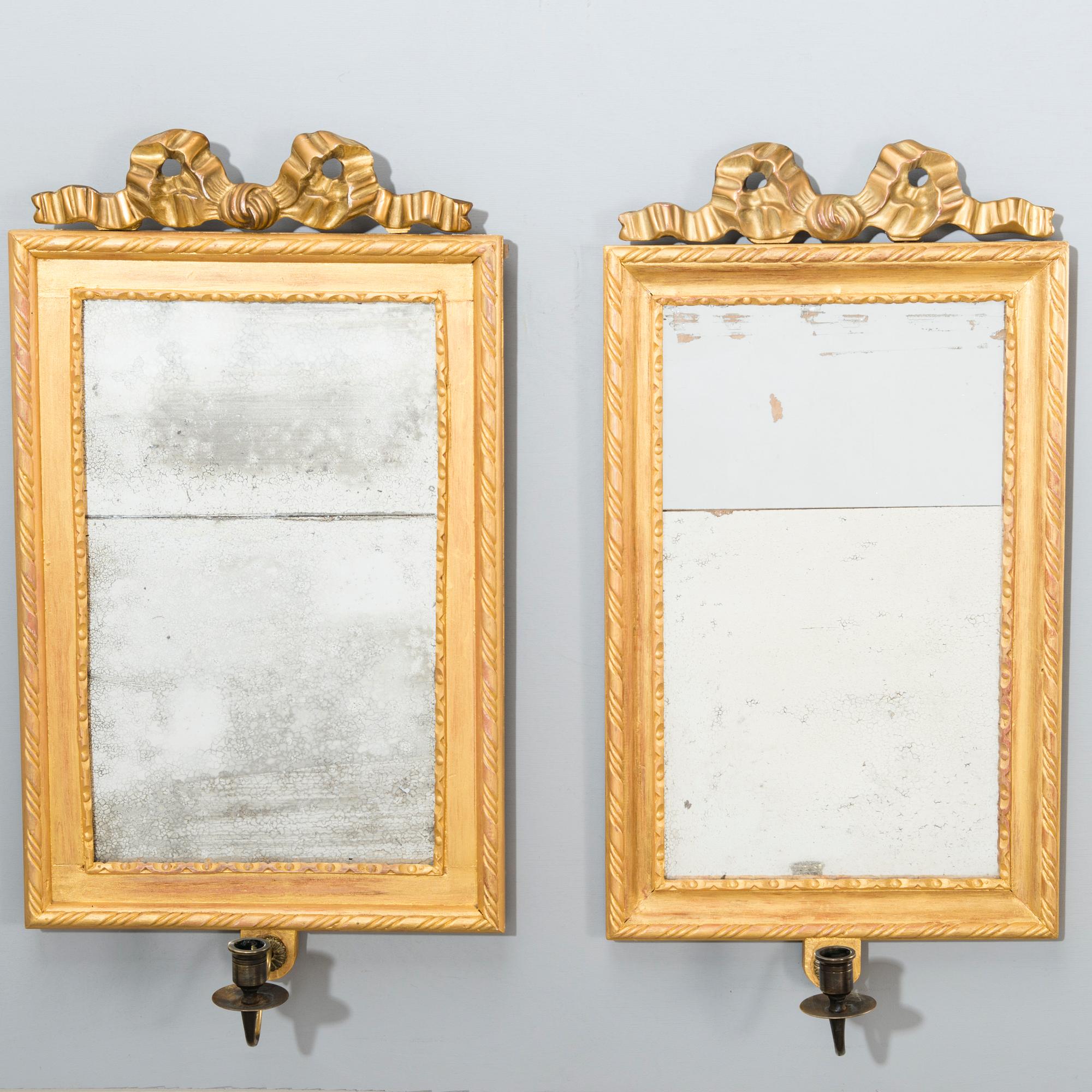 A pair of mirrored wall sconces from the latter half of the 20th century.