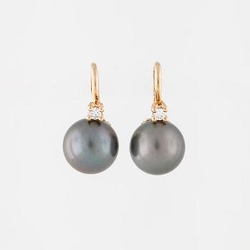 A pair of cultured Tahiti pearl and brilliant cut diamond earrings.