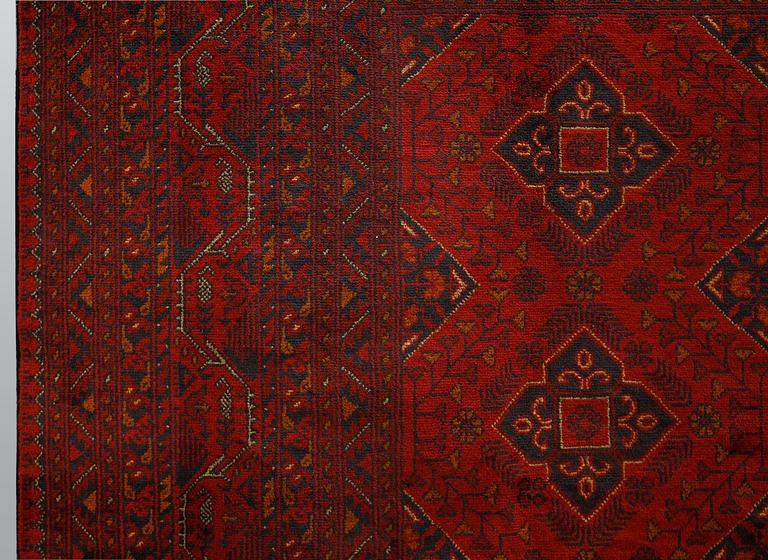 An Afghan carpet, 343 x 243 cm.