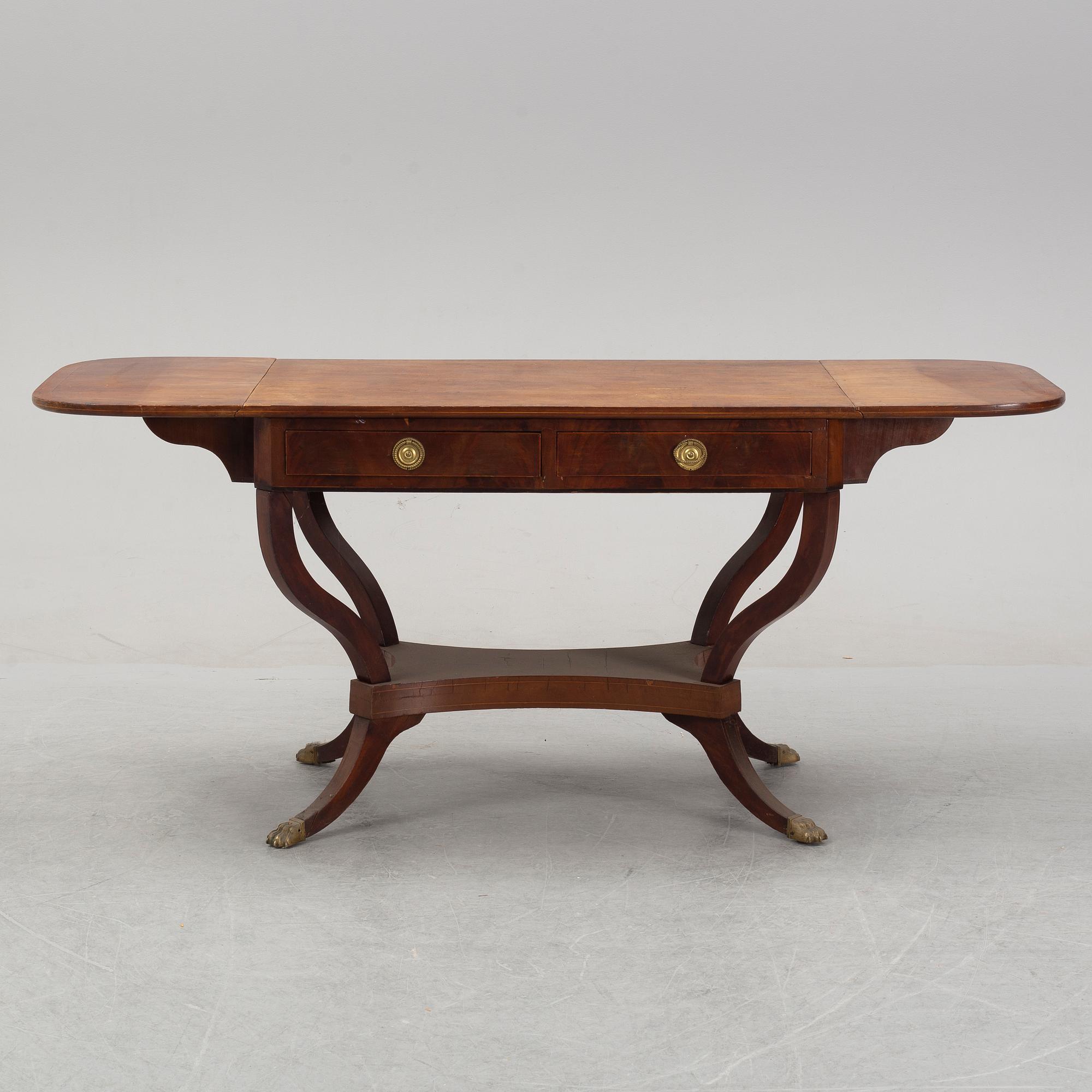 An Empire style mahogany  center table from around the year 1900.