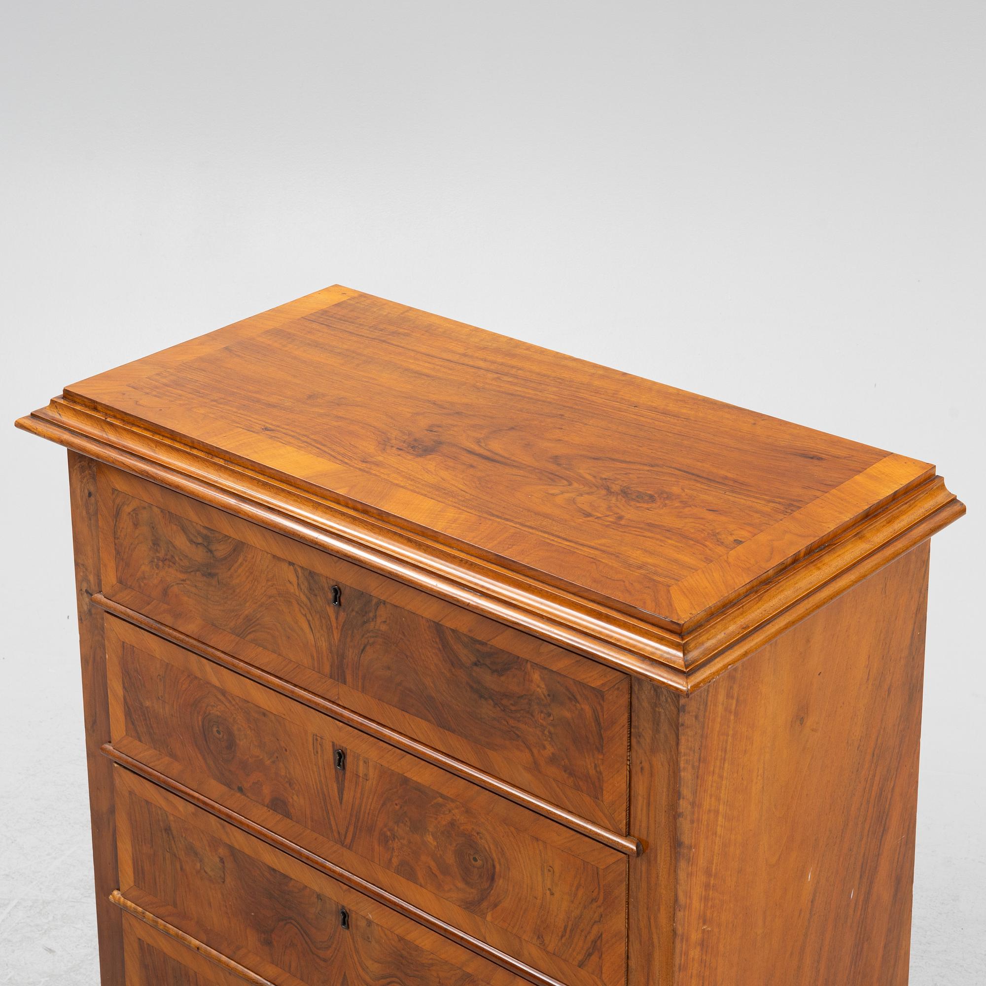 A walnut-veneered dresser, around 1900.
