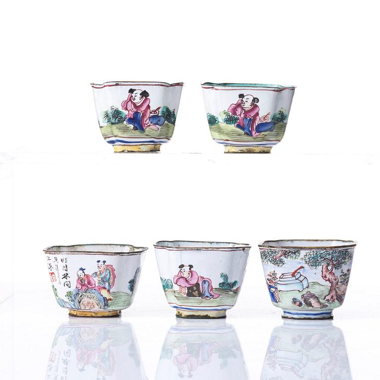 A set of five enamel on copper tea cups and a dish, Qing dynasty, circa 1800.