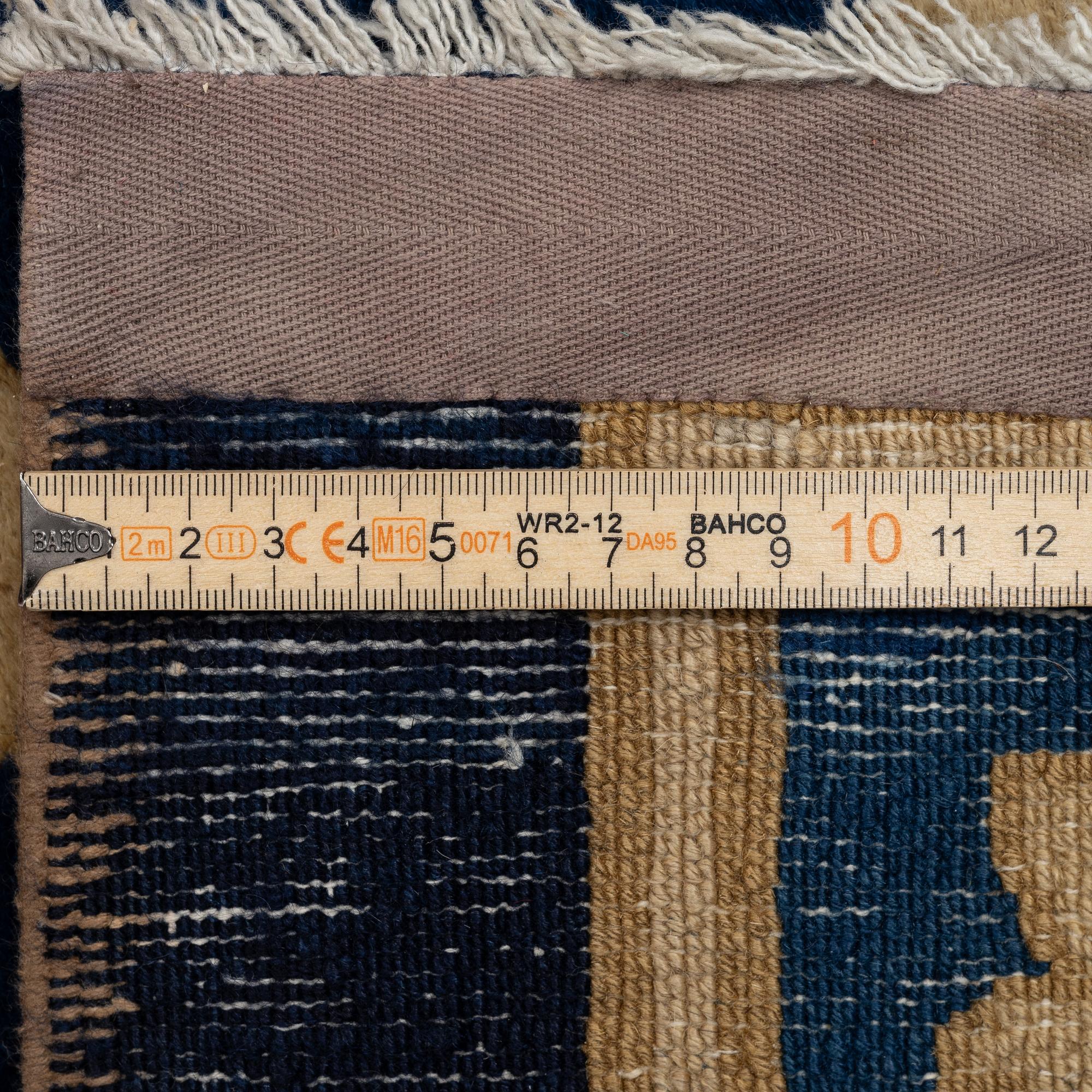 An antique Peking carpet, north China, c. 438 x 373 cm.