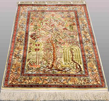 An Oriental figural silk rug, ca 117 x 78 cm.