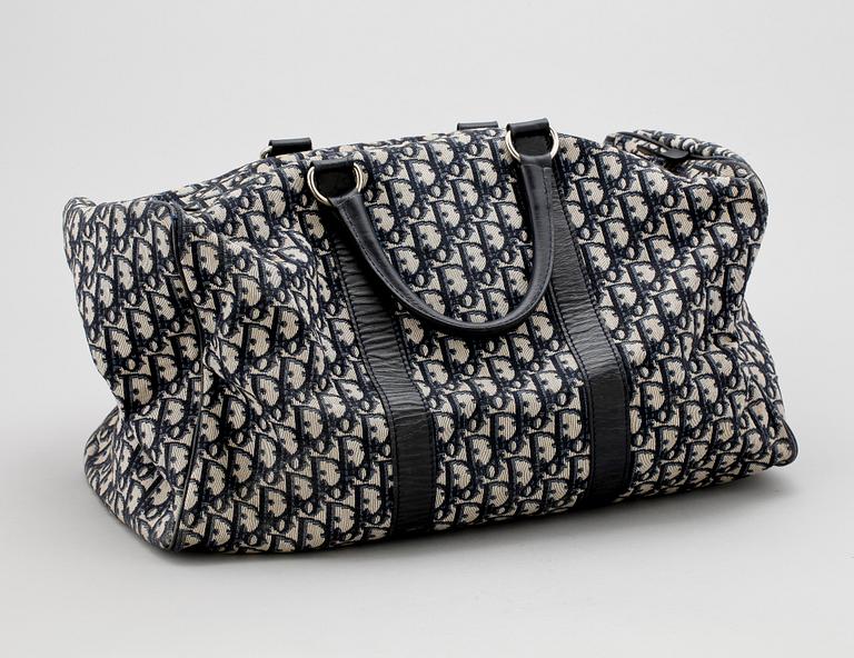 A blue monogram canvas weekendbag by Christian Dior.