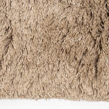 A monochrome carpet, 'Fallingwater - Mocha' by Layered, ca 400 x 300 cm.