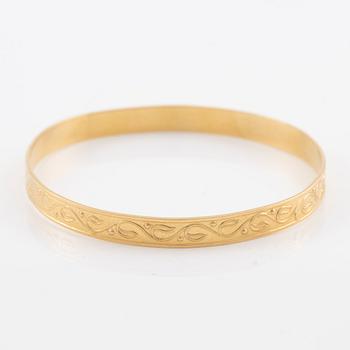 Arm ring, 18K gold with stylised decoration.