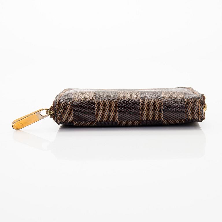 Louis Vuitton, a 'Zippy Coin Purse' wallet and an 'Inventeur' belt.