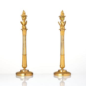 A pair of ormolu three-branch Empire candelabra, early 19th century.