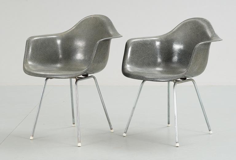 A pair of plastic chairs by Charles and Ray Eames.