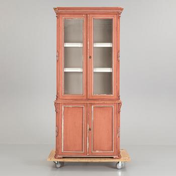 A pained late 19th century vitrine book cabinet in two sections.