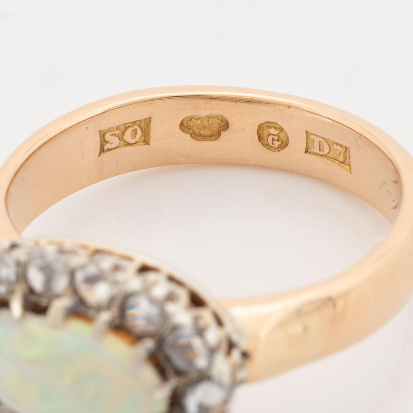 An 18K gold and opal ring set with rose-cut diamonds.