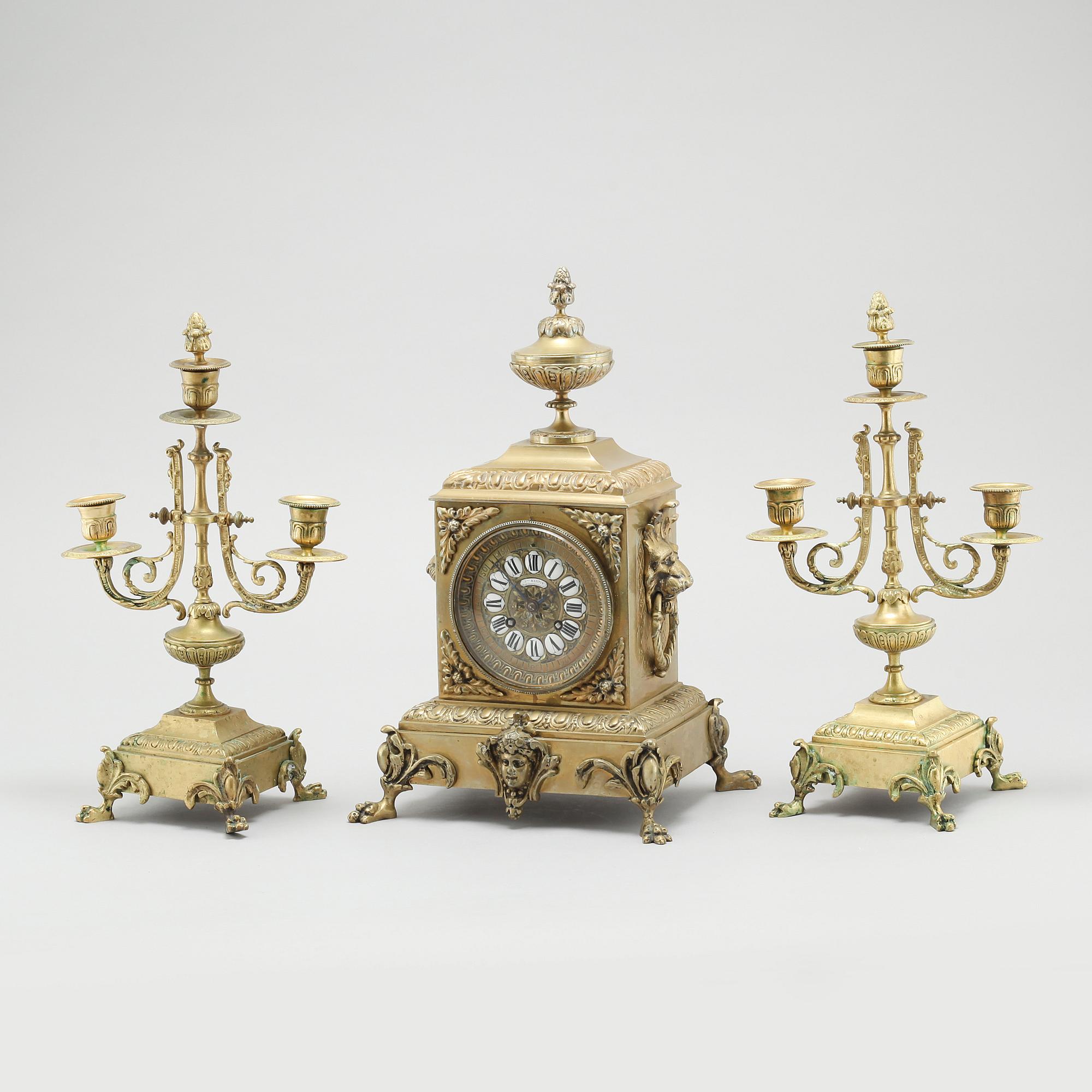 A table clock and two candelabras, around the year 1900.