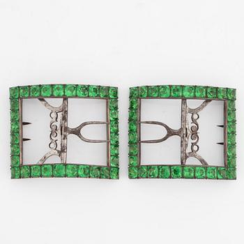 A pair of shoe buckles in white metal with green paste stones.