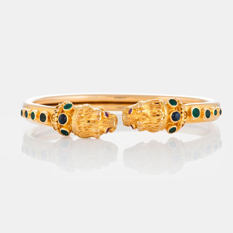 An Ilias Lalaounis bracelet in 18K gold set with emeralds, sapphires and rubies.