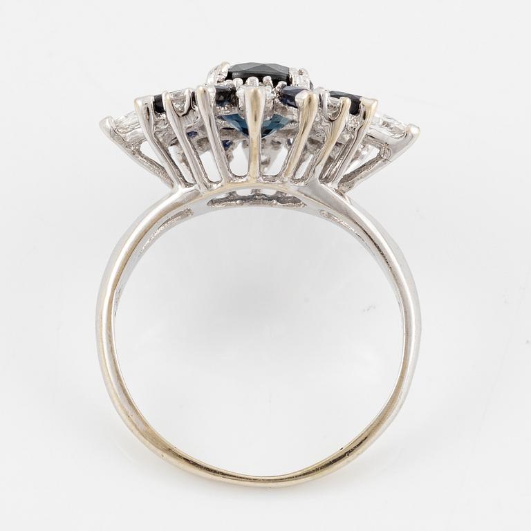 Ring 18K white gold with dark sapphires, pear-shaped and brilliant-cut diamonds.