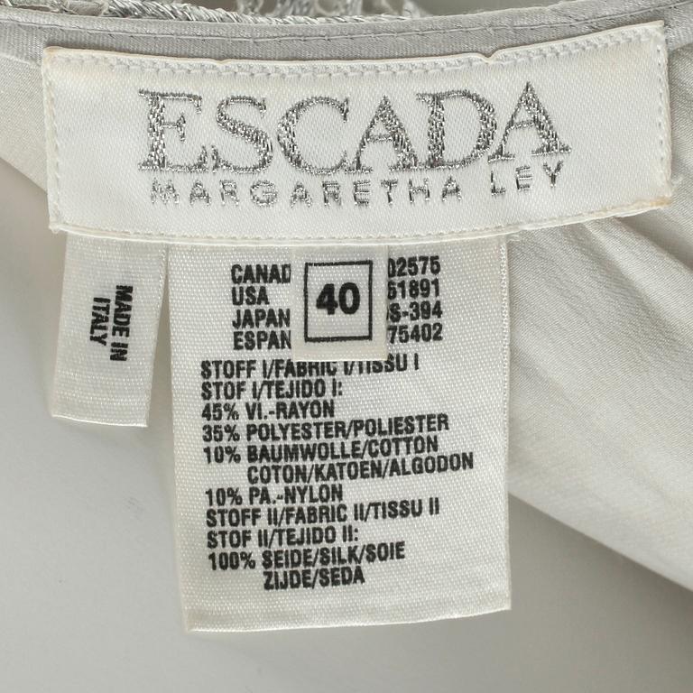 ESCADA, a silver colored sleeveless dress.