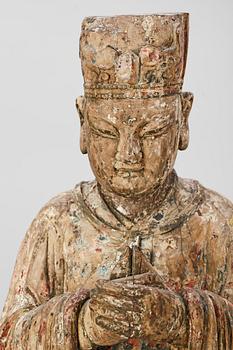 A wooden sculpture of a deity, Ming style.