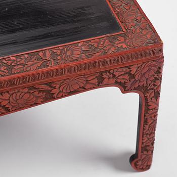 A carved lacquered table, early 20th Century.