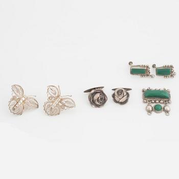 A silver belt buckle, three bracelets, two pairs of earrings, a pair of cuff-links and a brooch.