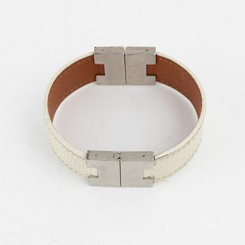 Hermès, a white leather bracelet.