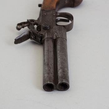 A British over-and-under flintlock pistol circa 1800.