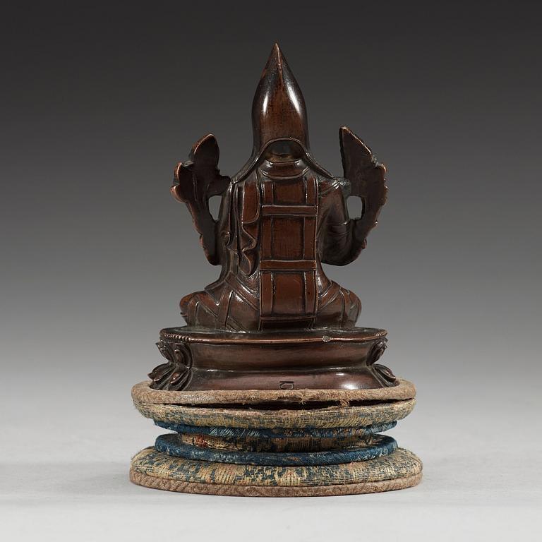 A copper alloy seated figure of a Tsong Khapa, presumably Nepal, 19th Century or older.