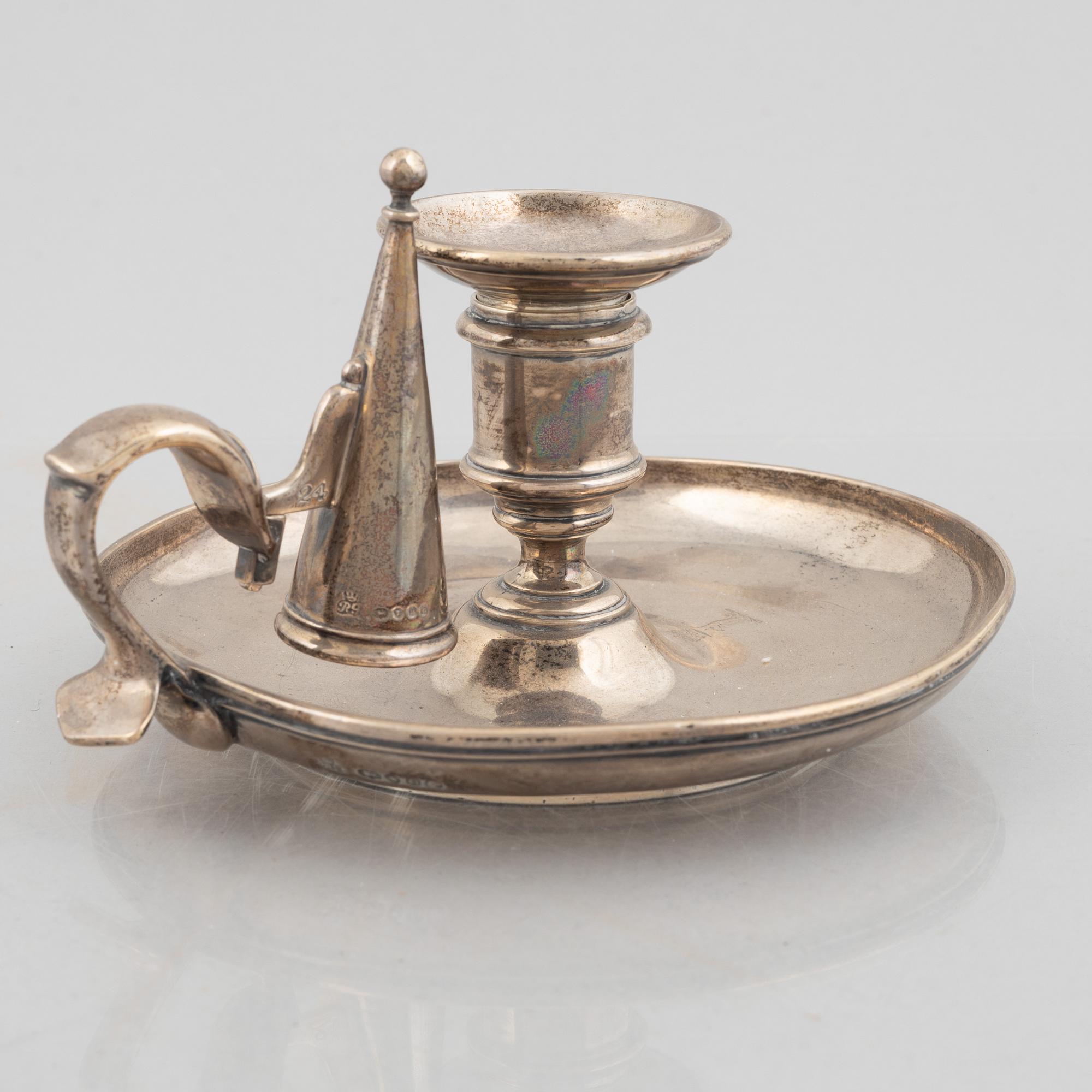 A silver chamber candlestick with mark of R & S Garrard & Co, London, England 1848.