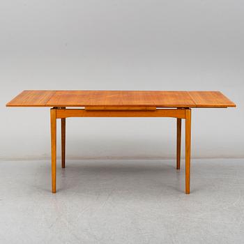 A second half of the 20th century teak veneered dining table.