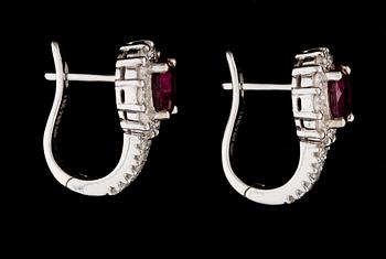 A pair of ruby and diamond earrings.