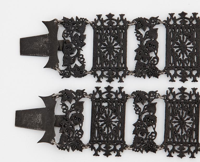 A Berlin steel and iron parure comprising a necklace, two bracelets and a brooch.