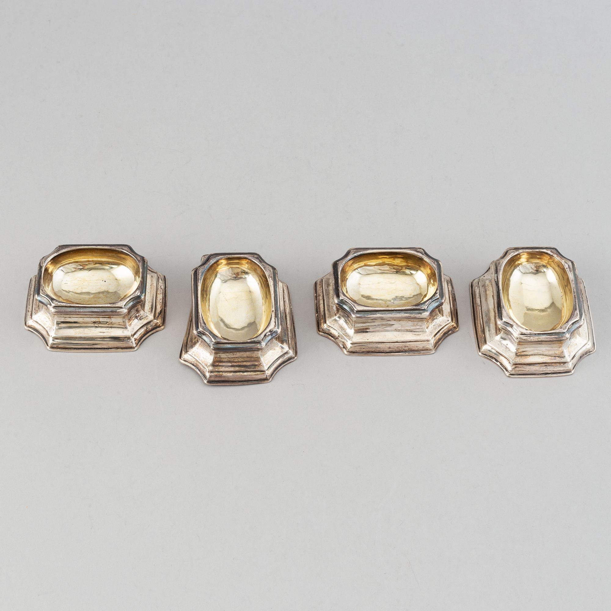 Four English early 18th century parcel-gilt silver salt-cellars, mark of Edward Wood, London 1727.