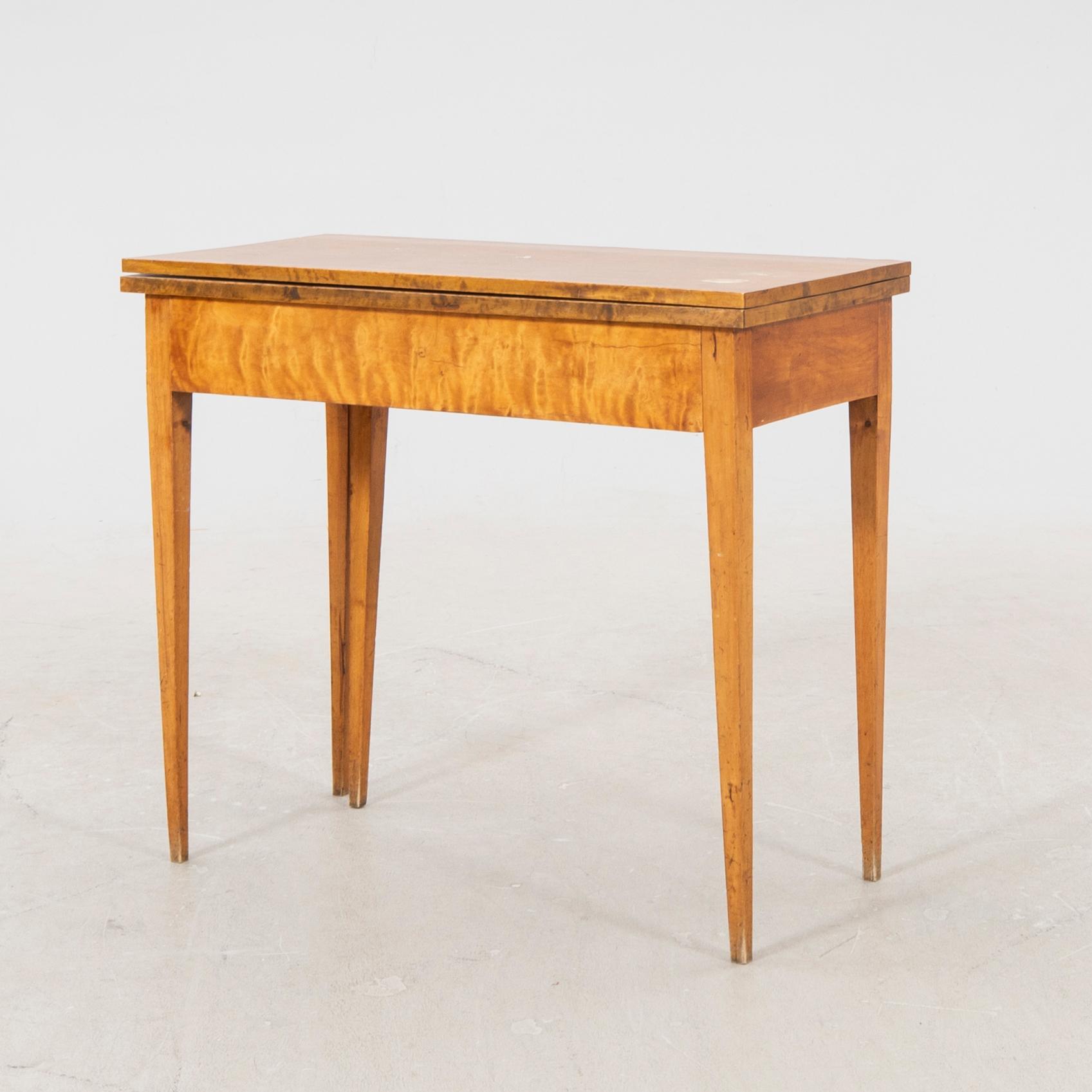 An earluy 1900s birch game table.