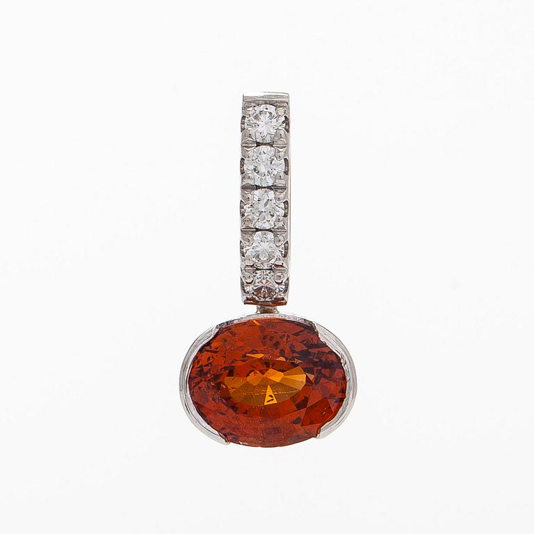 A 14K whitegold pendant, with a garnet and diamonds.