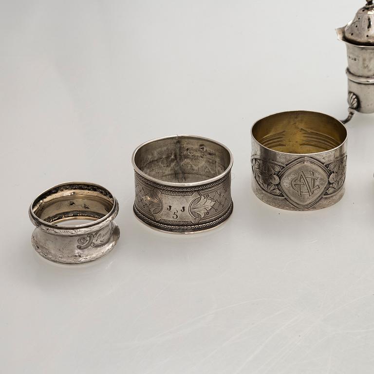 Napkin rings, 6 pcs, a pair of salt shakers, and salt cellars, silver and glass, including English and Finnish marks.