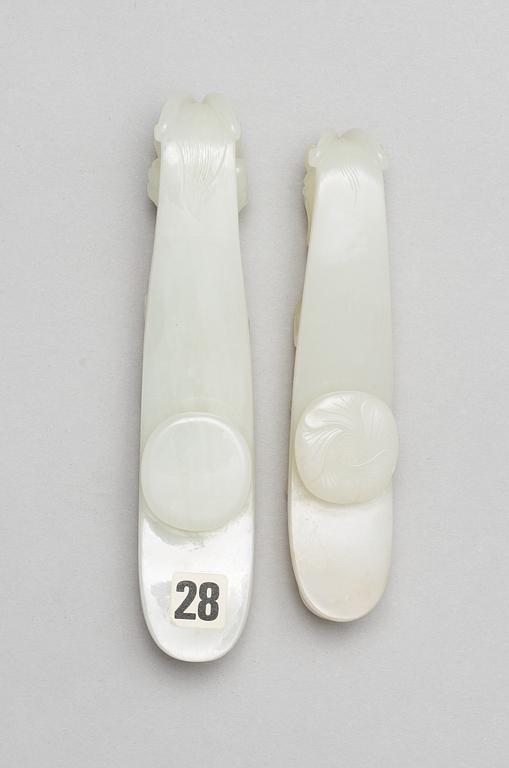 Two pale green nephrite garment hooks, Qing dynasty.