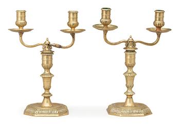 753. A pair of Swedish Baroque early 18th century bronze two-light candelabra.