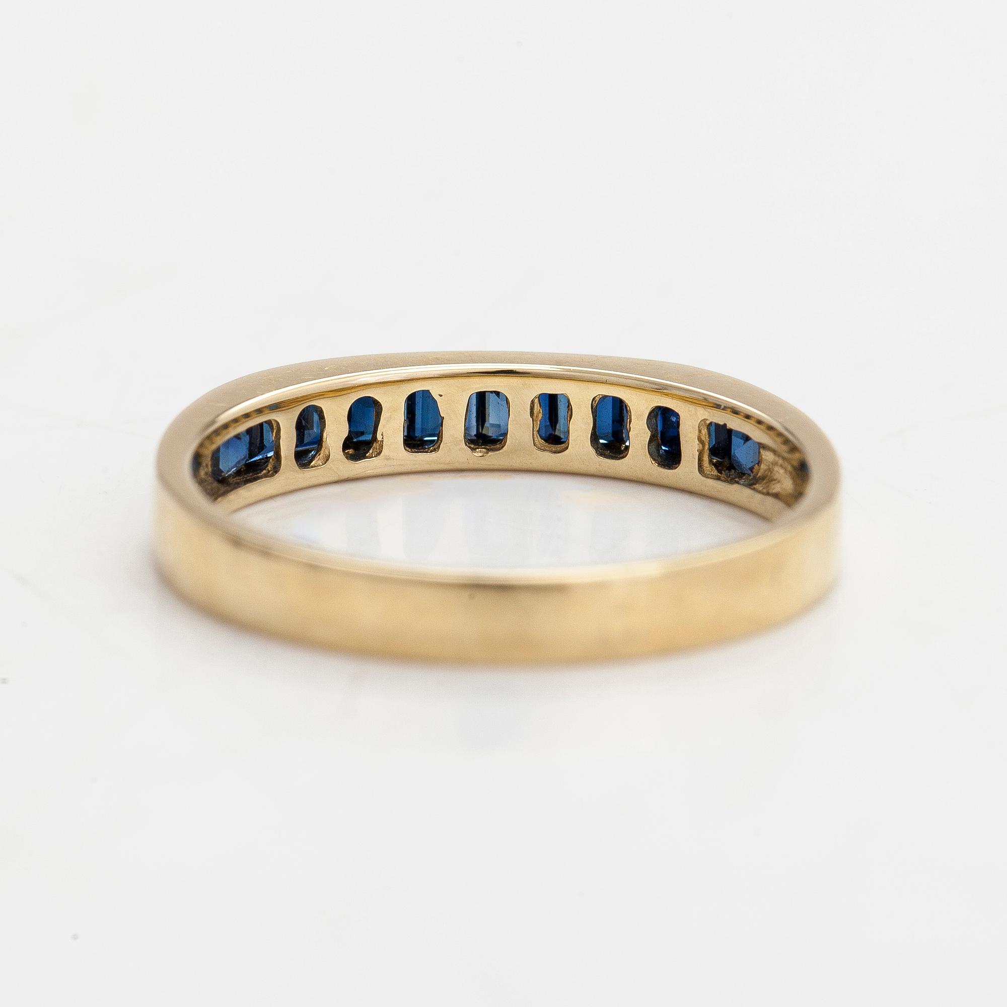A half-eternity 14K gold ring with sapphires.